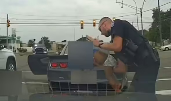 Astonishing moment a hero police officer Brendan Fraser resuscitates a baby in the middle of a highway.